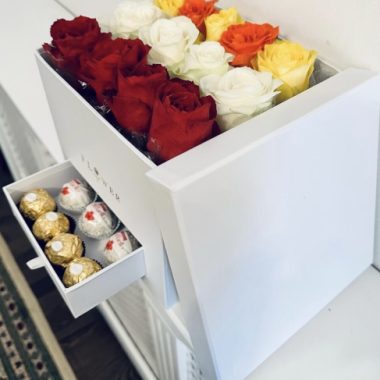 Flowers in a white box with chocolates
