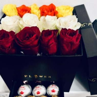 Flowers in a black box with chocolates