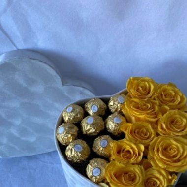Flowers in a box with chocolate